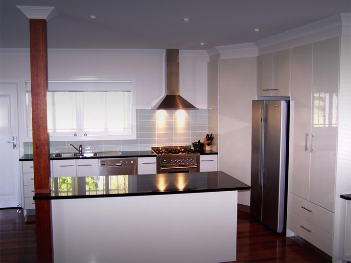 Kitchen Renovation With Black Bench White Cupboards and State-of-the-art Stainless Steel Cooking Unit